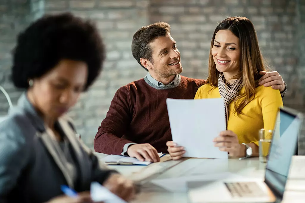 Couple Smiling Reading Document